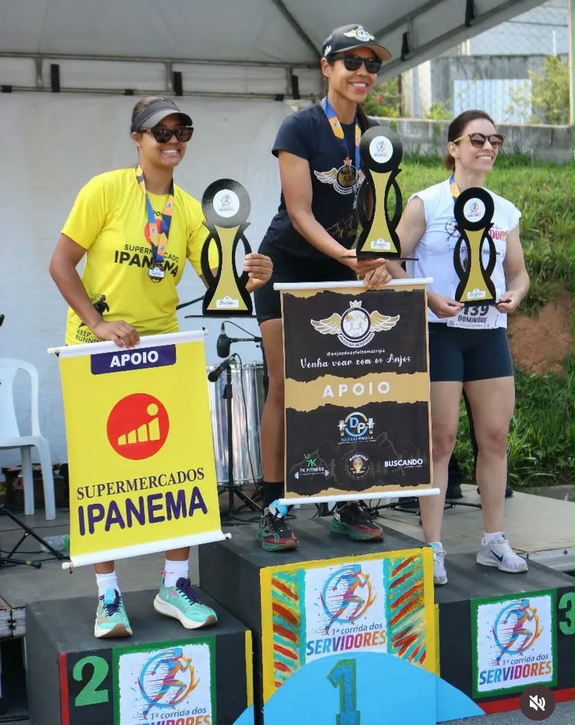 Pódio feminino com flâmulas dos apoiadores do evento